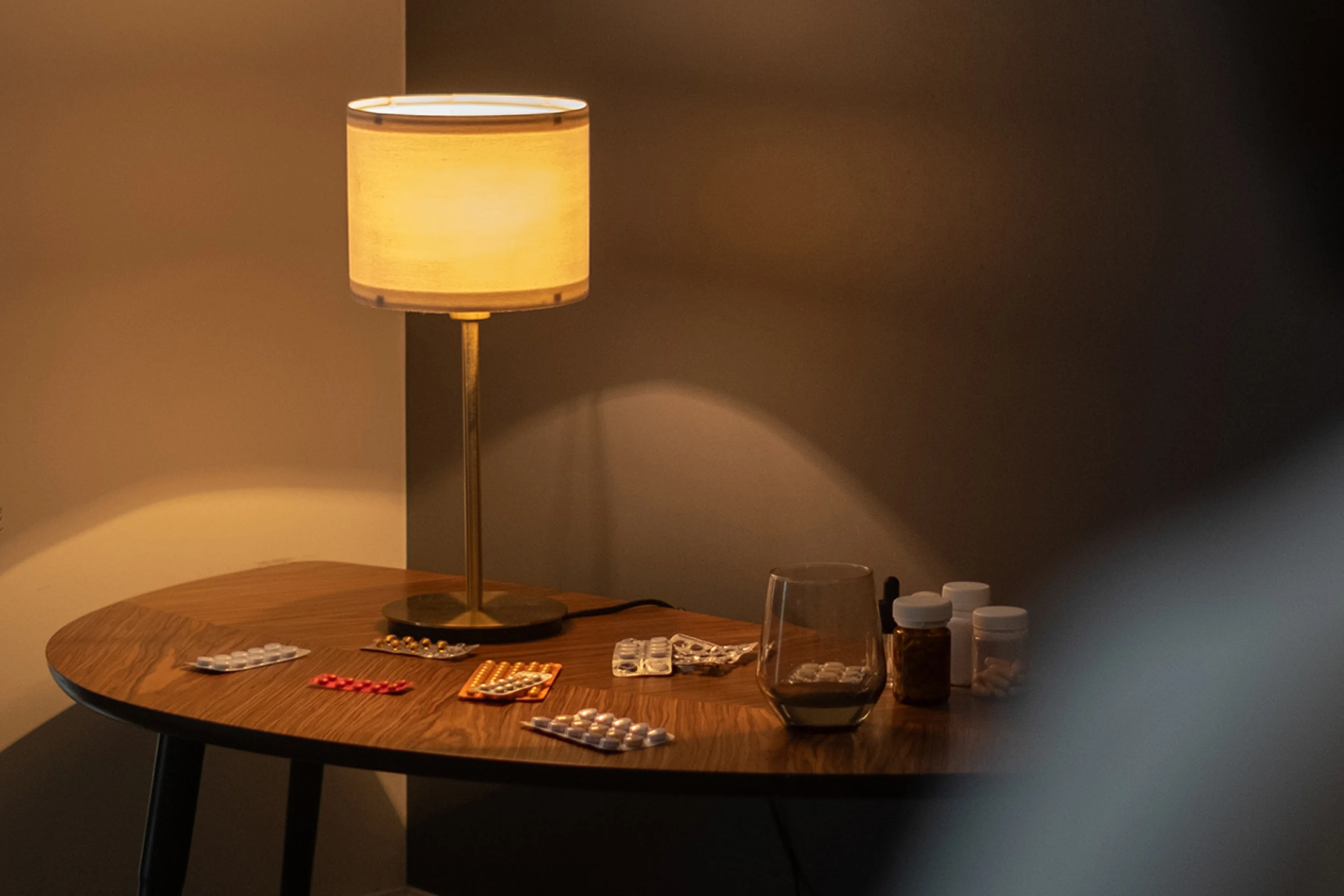 packets of medication and a lamp on a table